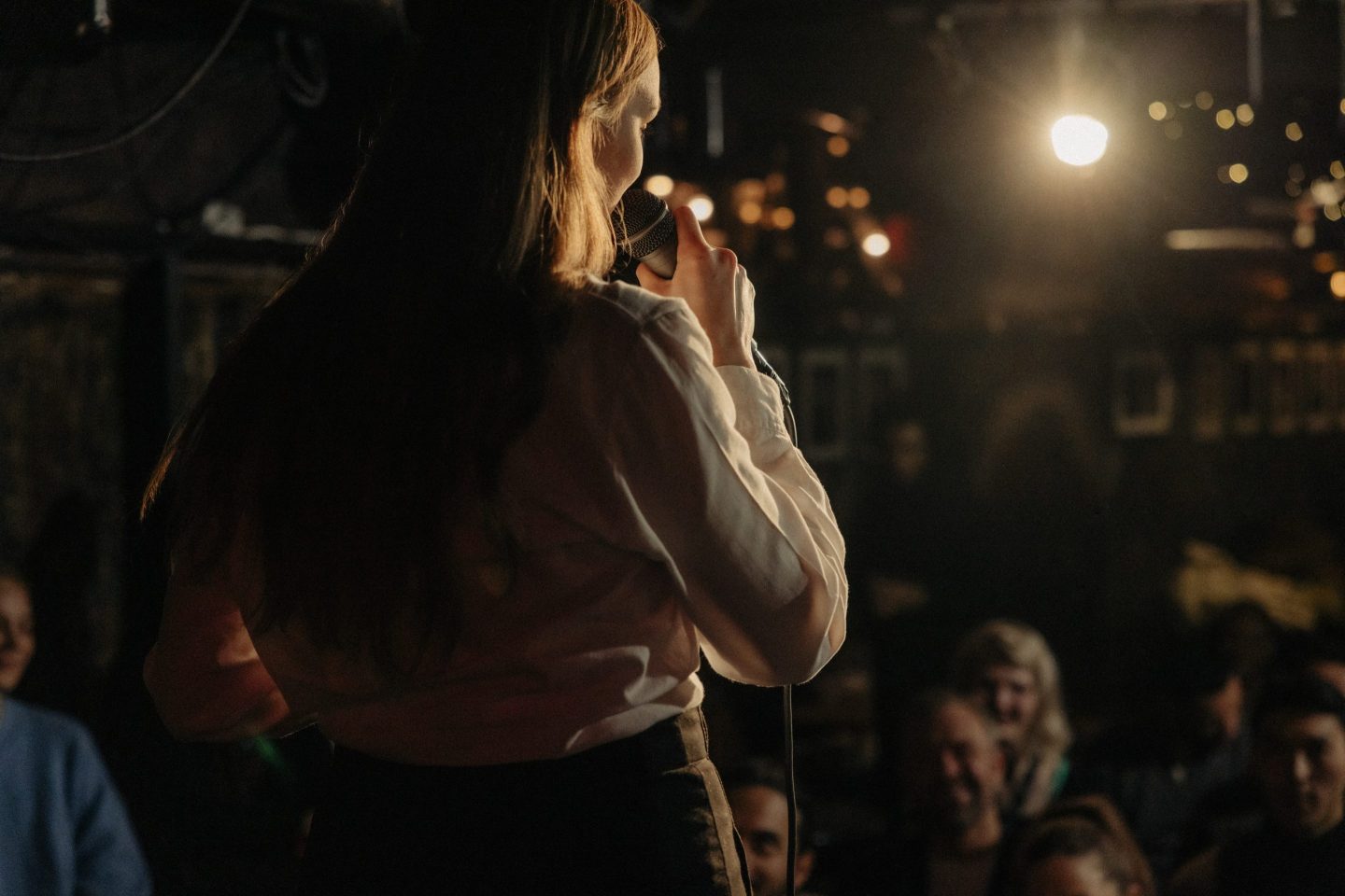 Rear view of woman performing stand-up comedy