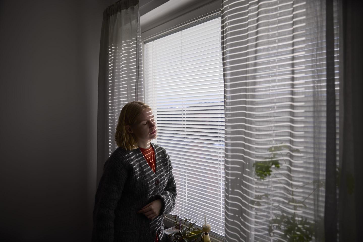 Woman staring out window