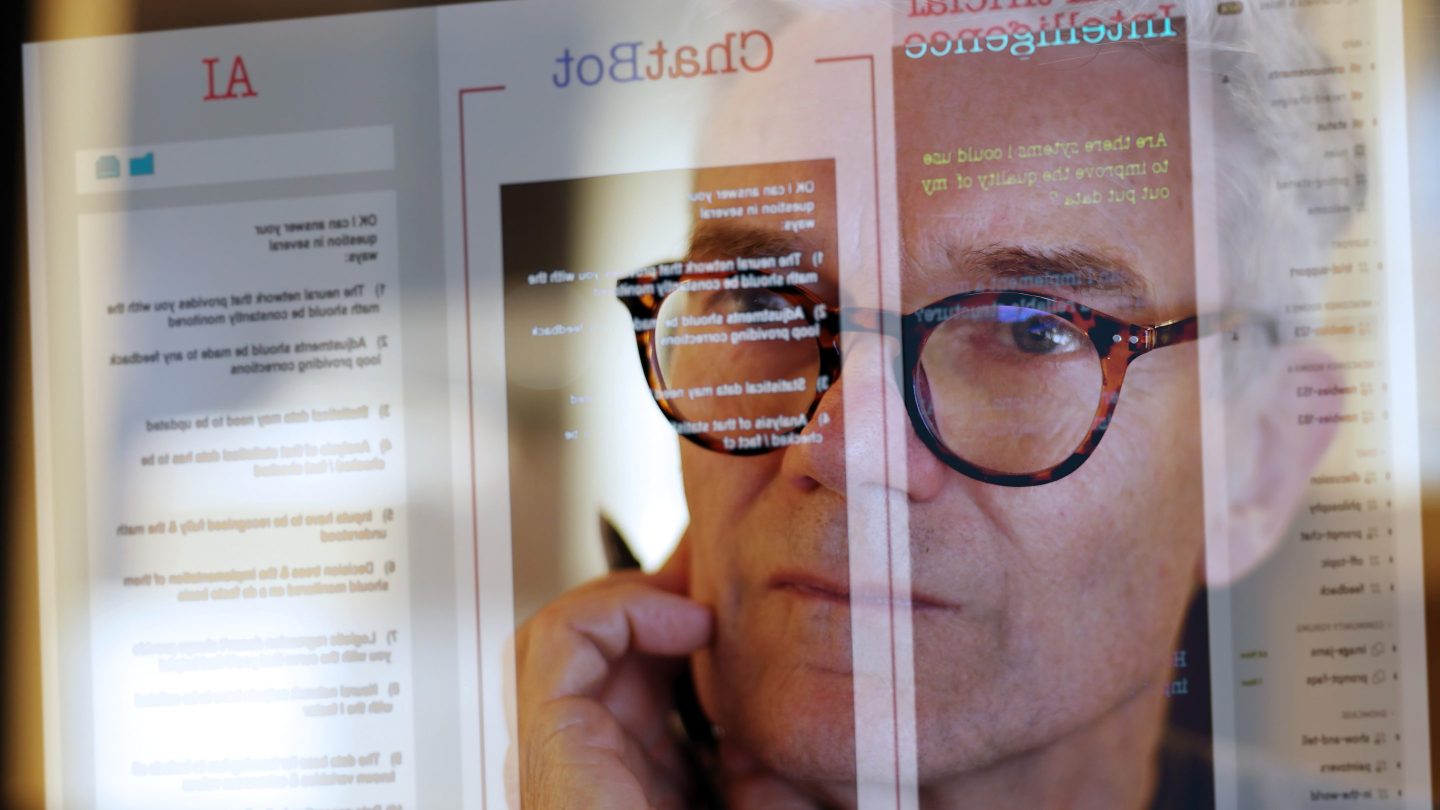 Man looking at text on a screen generated by artificial intelligence