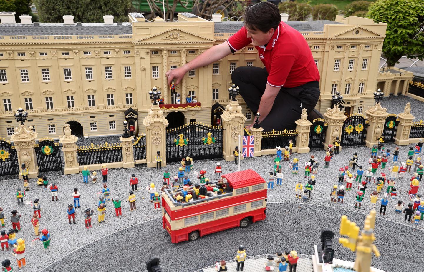 a man sitting among Lego bricks of the Windsor castle