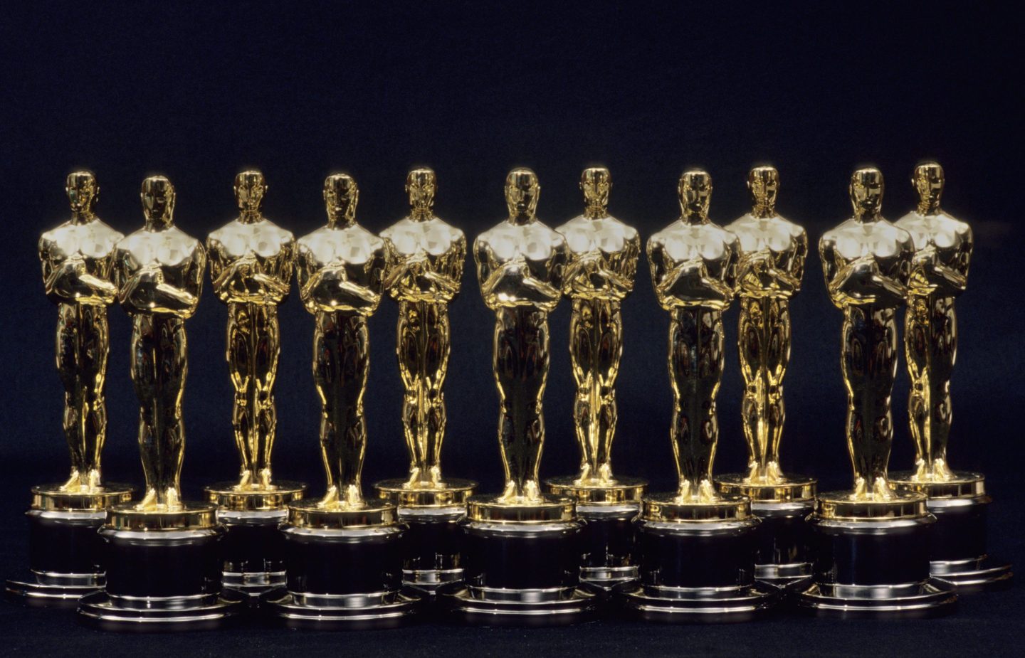 Photo of 11 Oscars statues lined up next to one another in 1990 in Los Angeles