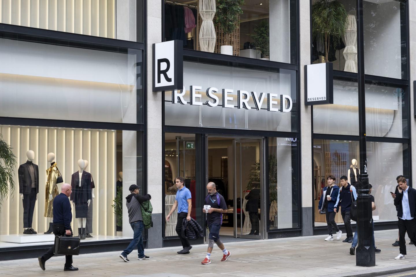 Shoppers and visitors out on Oxford Street pass newly opened store Reserved.