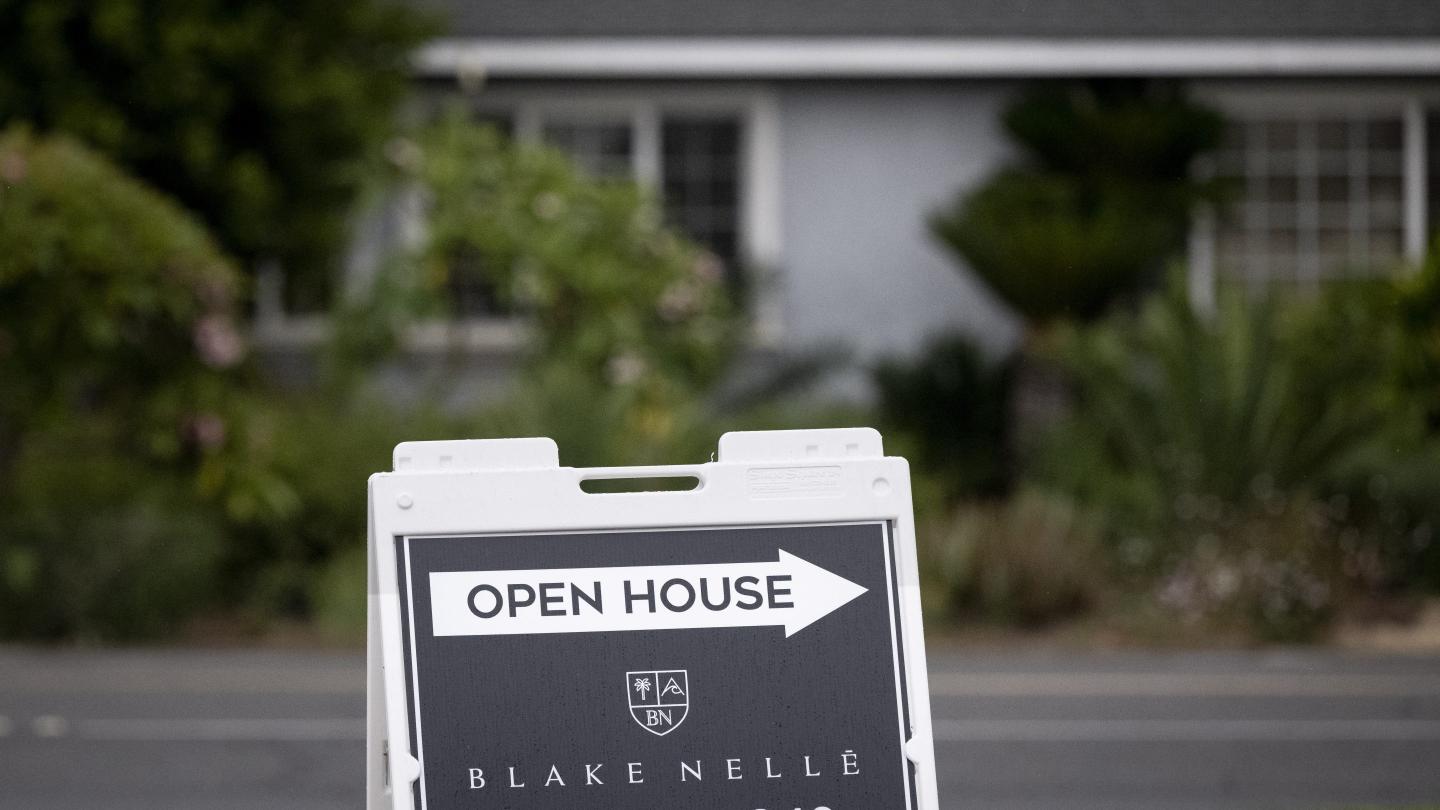 An open house sign sits outside a home in the 18000 block of Weston Place in Tustin, CA