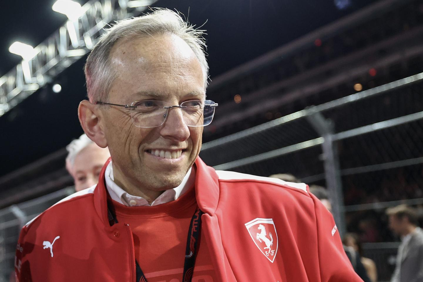 CEO Benedetto Vigna is wearing a red and white Ferrari jacket and standing trackside at the 2023 Las Vegas Grand Prix.