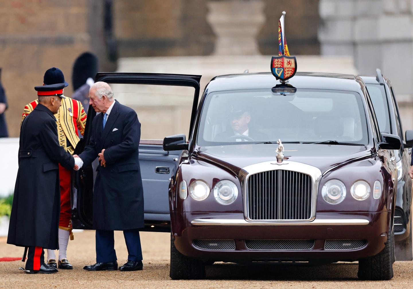 Photo of King Charles III getting out of a Bentley limousine