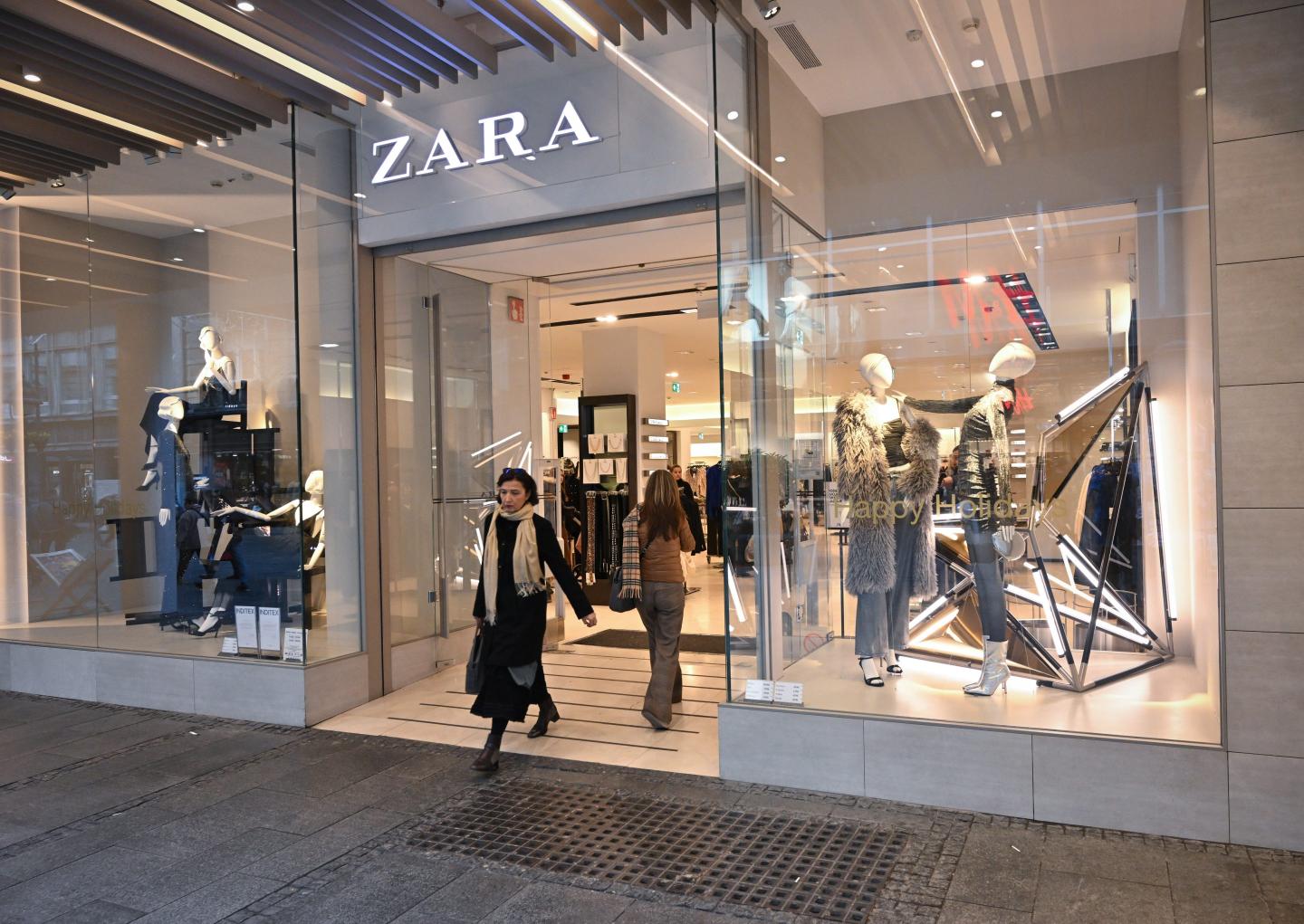 person carrying zara shopping bags