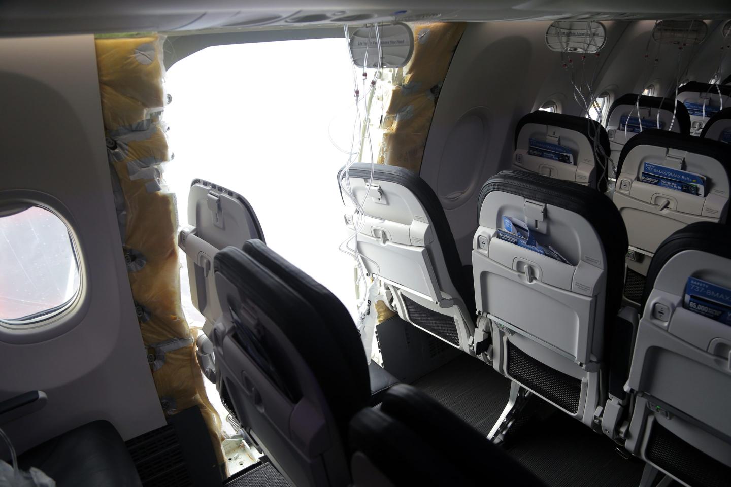 an opening is seen in the fuselage of Alaska Airlines Flight 1282 Boeing 737-9 MAX