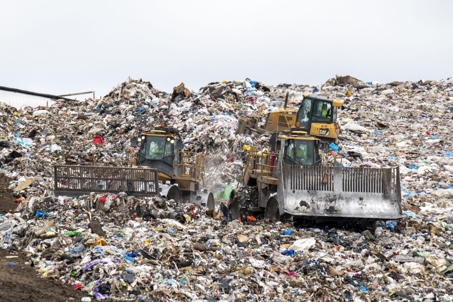 Bulldozers move trash at a landfill refuse site in Minnesota.