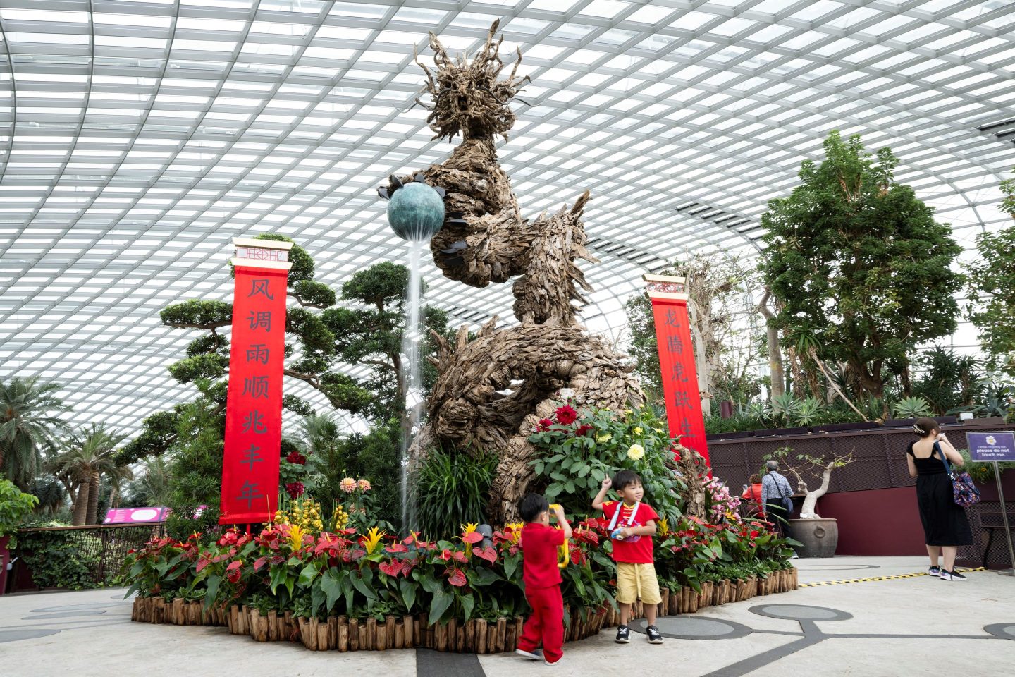 Children visit a Chinese New Year decoration at the Flower Dome of Gardens by the Bay in Singapore.