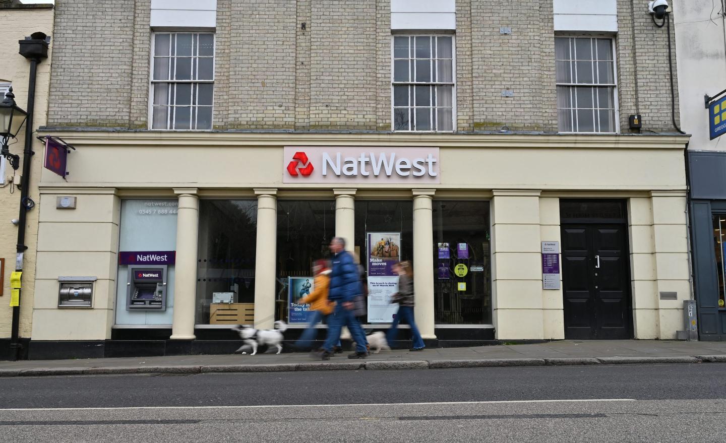 people walking outside a NatWest bank branch