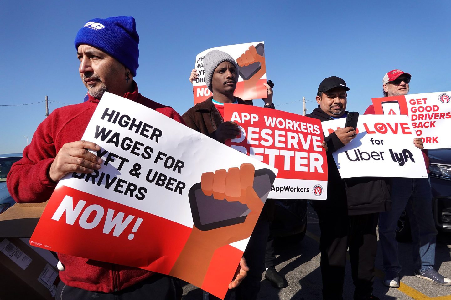 Rideshare drivers rally at a staging area