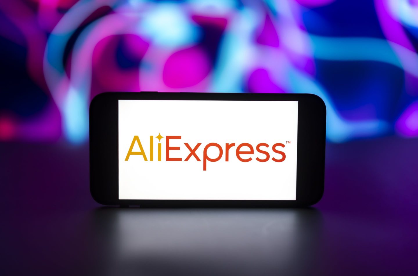 In this photo illustration, the AliExpress logo is seen displayed on a mobile phone screen.