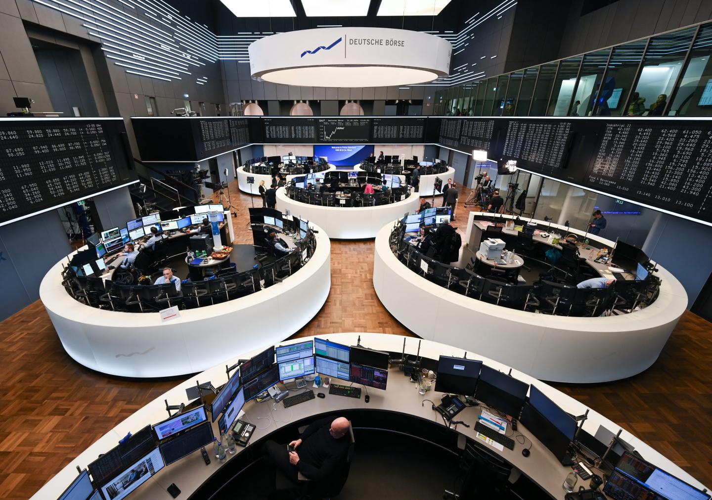 Stock traders from various companies work in five circular and one semi-circular trading floor at the Frankfurt Stock Exchange.