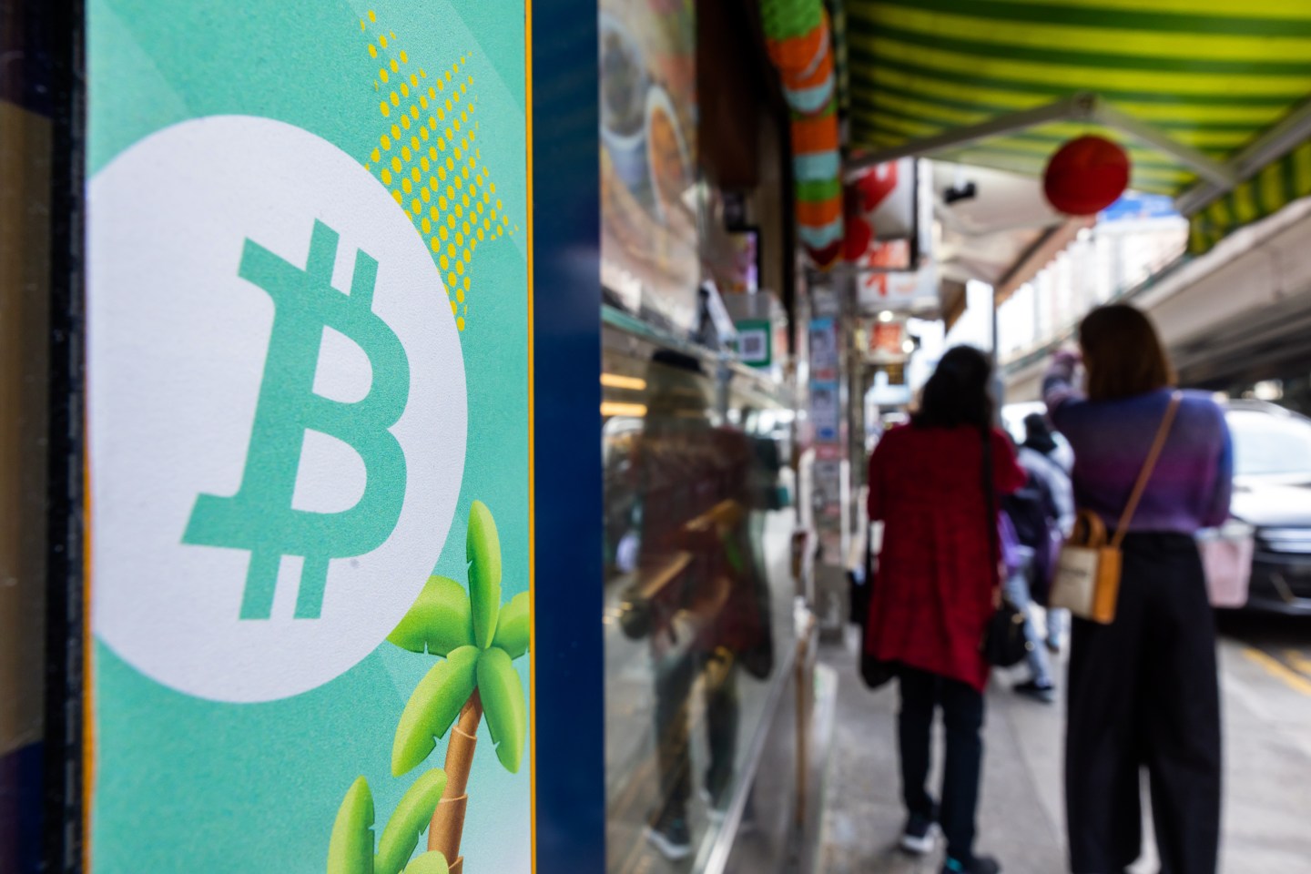 A Bitcoin logo displayed on a cryptocurrency ATM in Hong Kong, China.