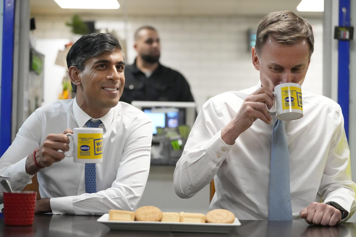 U.K. Prime Minister Rishi Sunak, left and UK Chancellor Jeremy Hunt have a drink and biscuits.