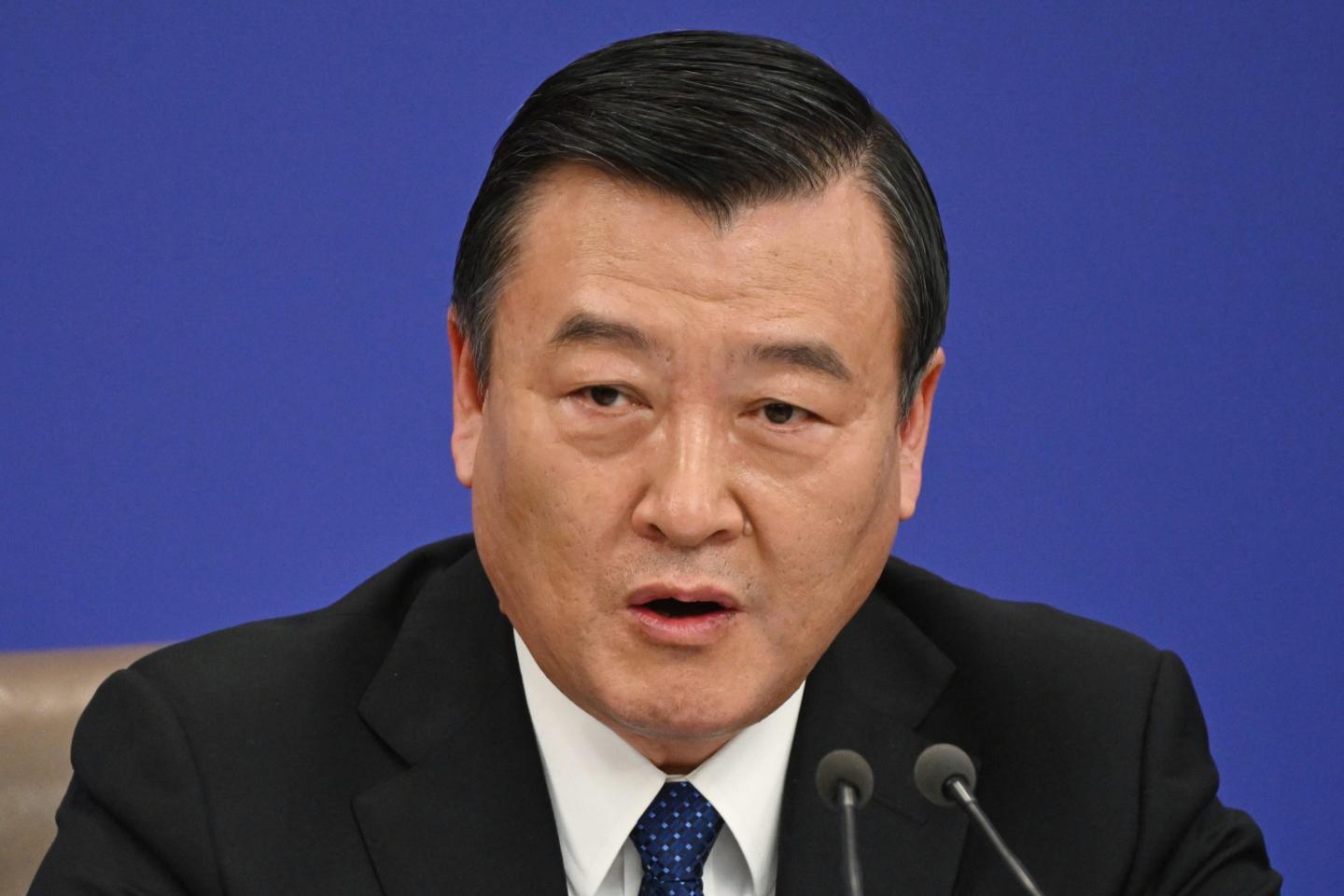 Chinese minister Ni Hong speaking at a press conference.