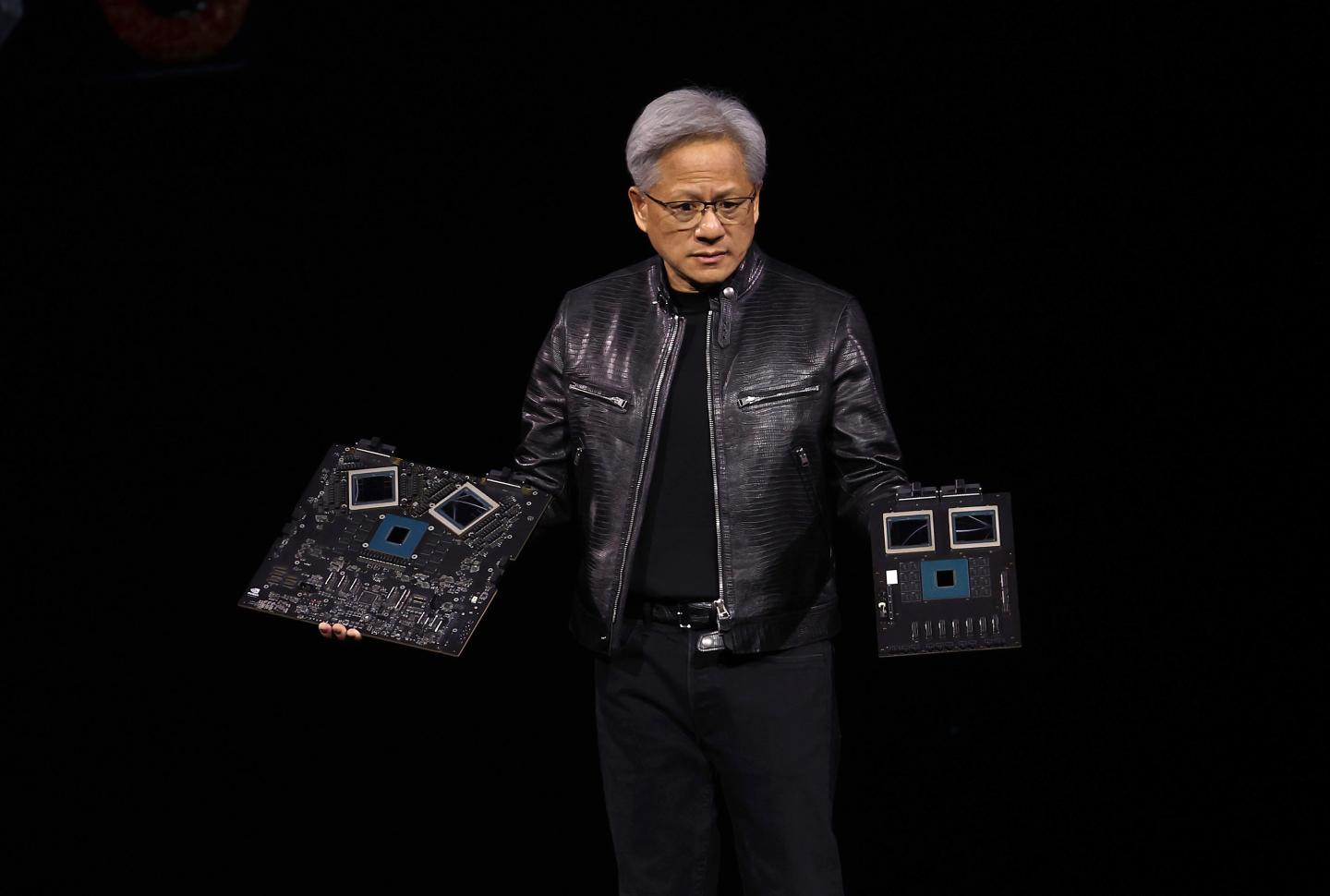 Nvidia CEO Jensen Huang holding the company's latest GB200 system.