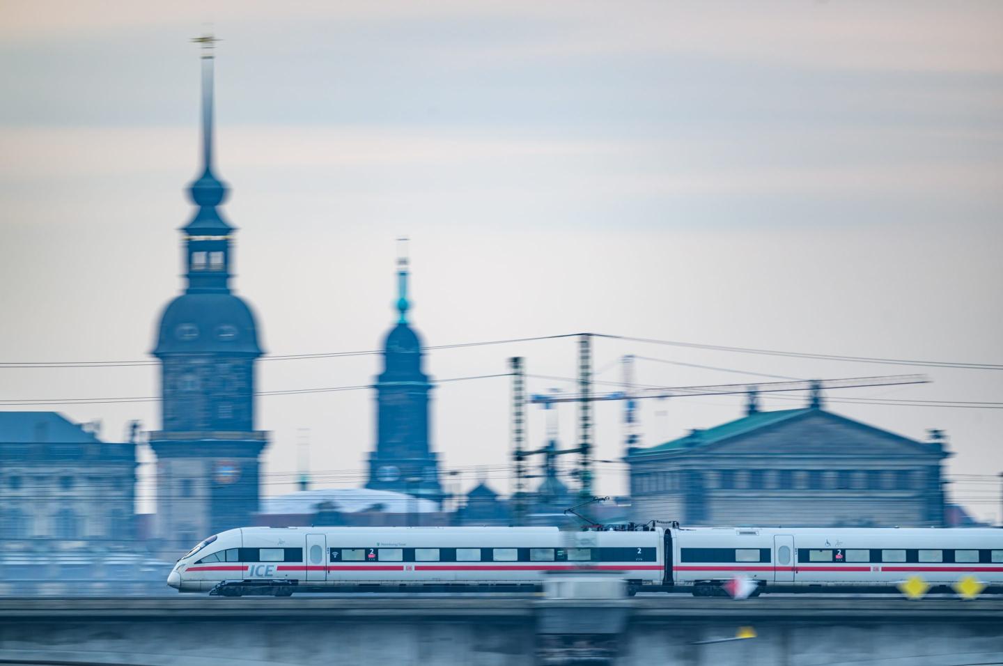 A Deutsche Bahn ICE train crosses the Marienbrücke bridge in the morning