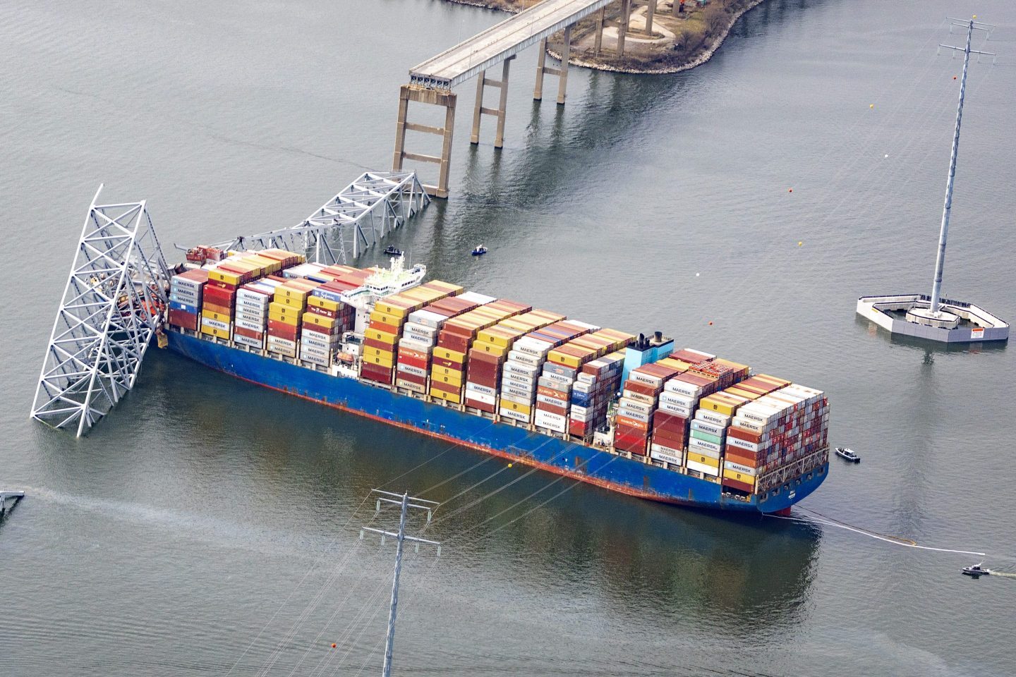 The Dali shipping container abuts the fallen Francis Scott Key Bridge.