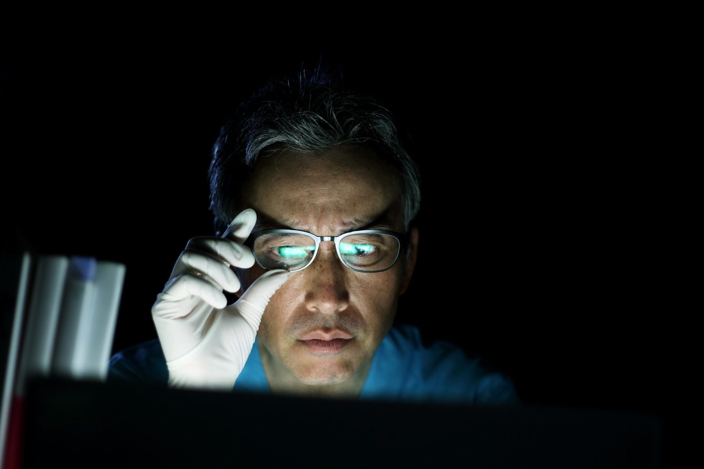 Man looking at laptop in the dark