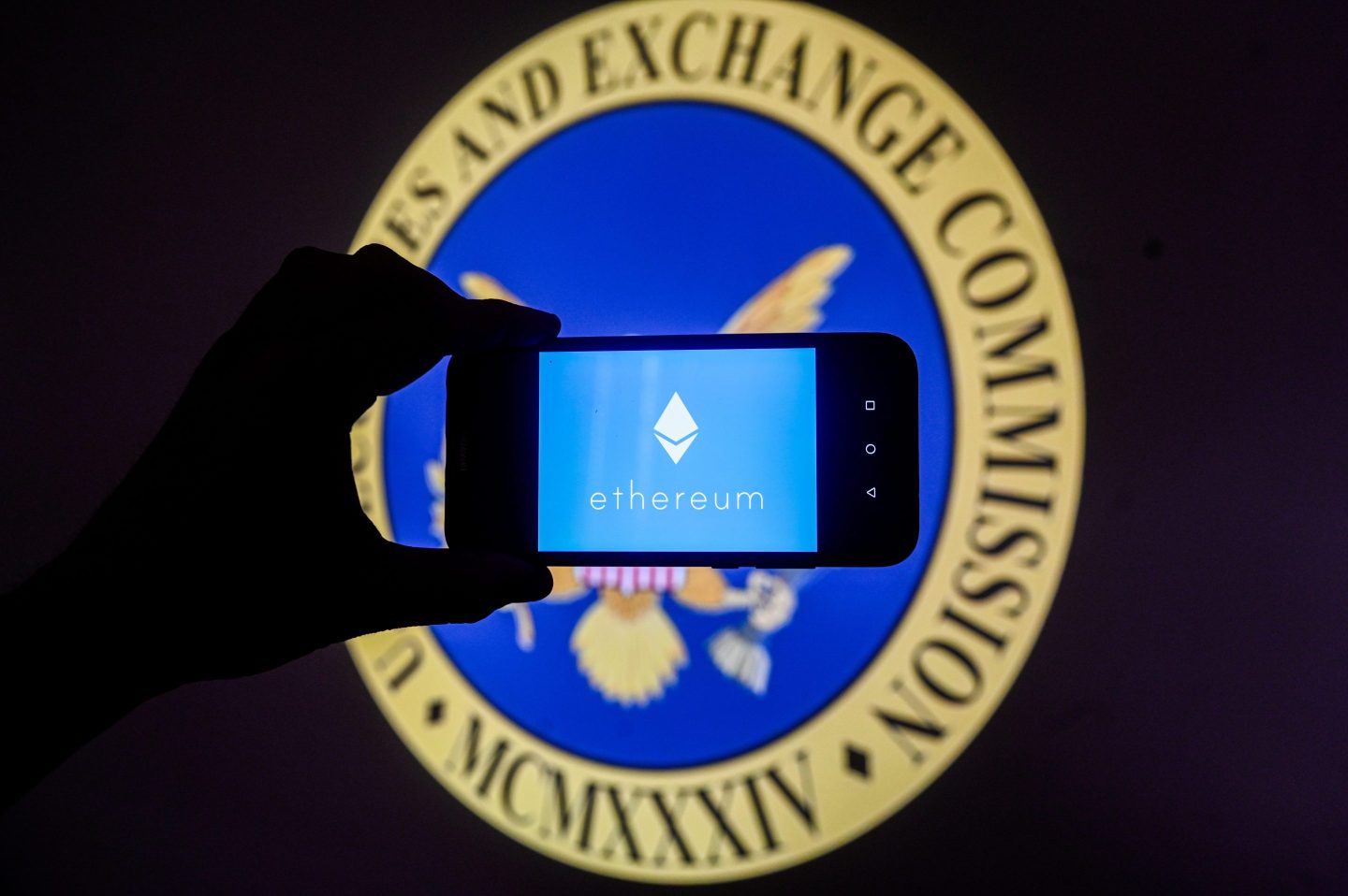 POLAND &#8211; 2024/01/17: In this photo illustration an Ethereum logo is displayed on a smartphone with US Securities and Exchange Commission (SEC) logo in the background. (Photo Illustration by Omar Marques/SOPA Images/LightRocket via Getty Images)