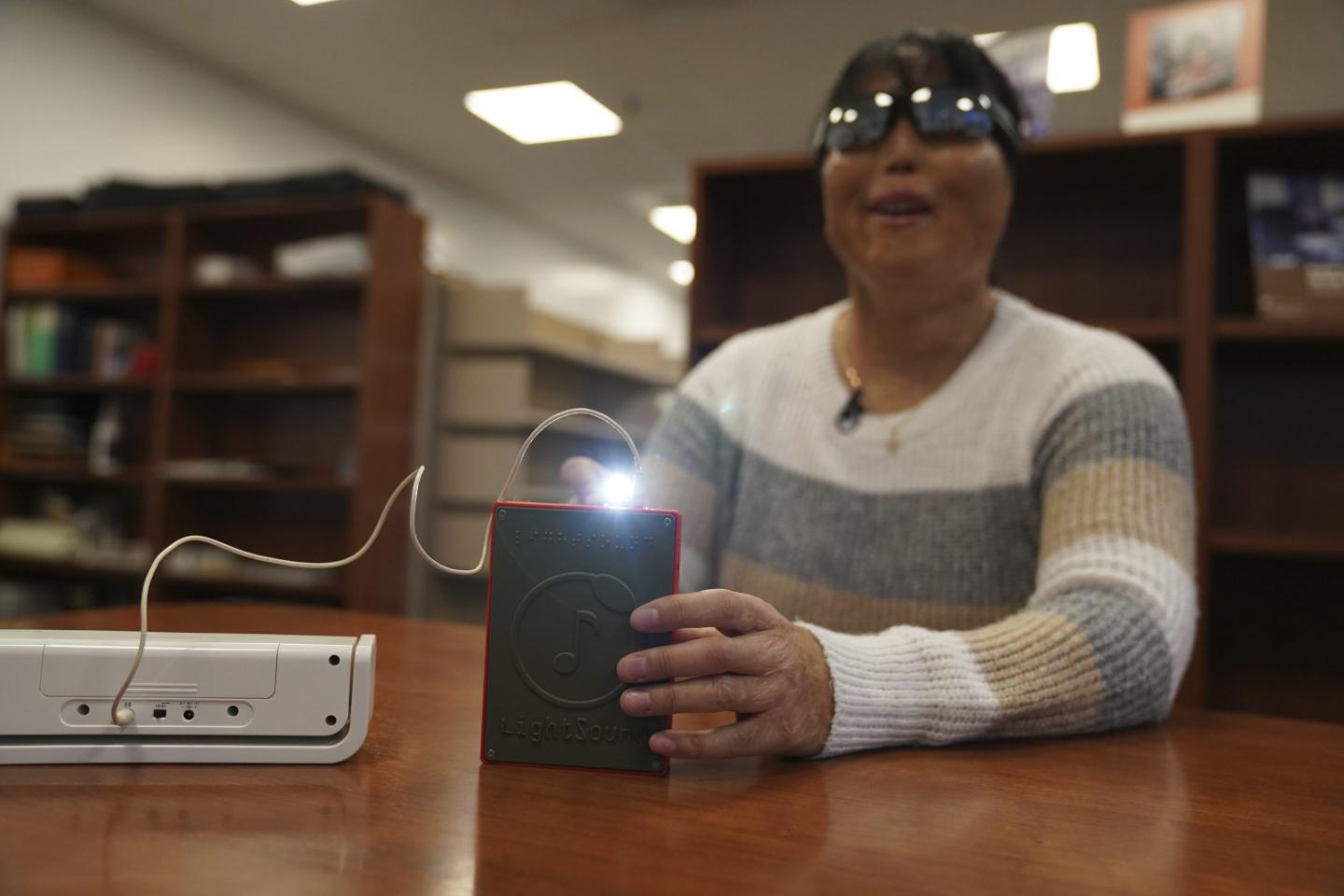 Woman using light-to-sound device