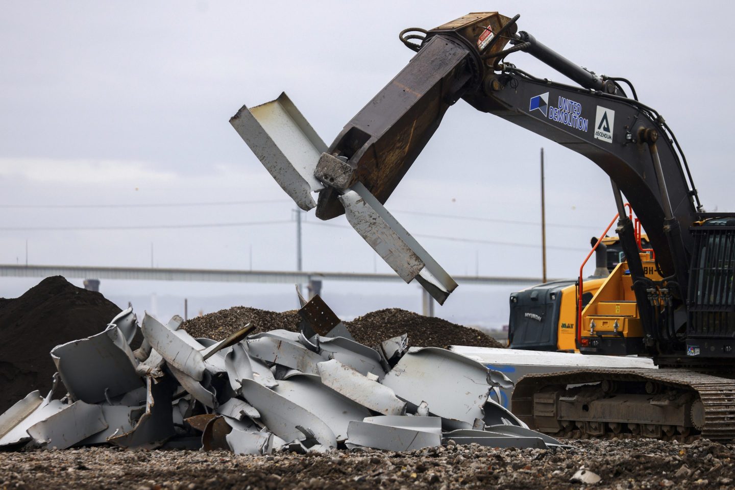 A shearer breaks apart salvaged pieces of the collapsed Francis Scott Key Bridge at Tradepoint Atlantic, on April 12, 2024, in Sparrows Point, Md. 