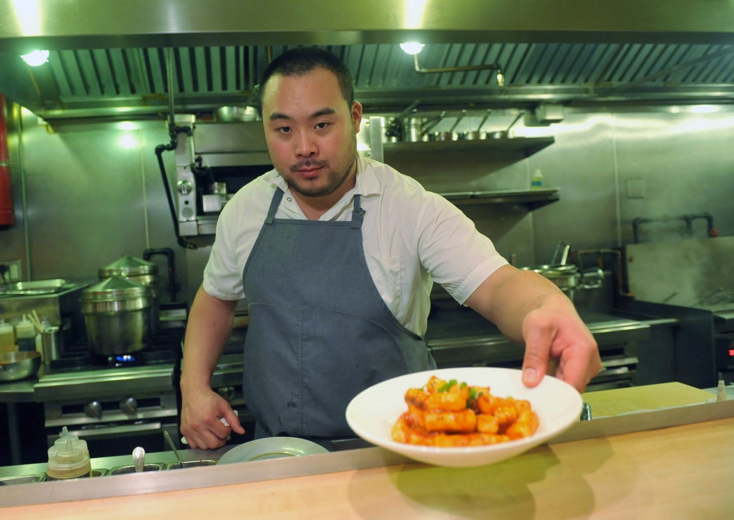 David Chang presents a dish at Momofuku Noodle Bar in New York on Thursday, Nov. 10, 2011.