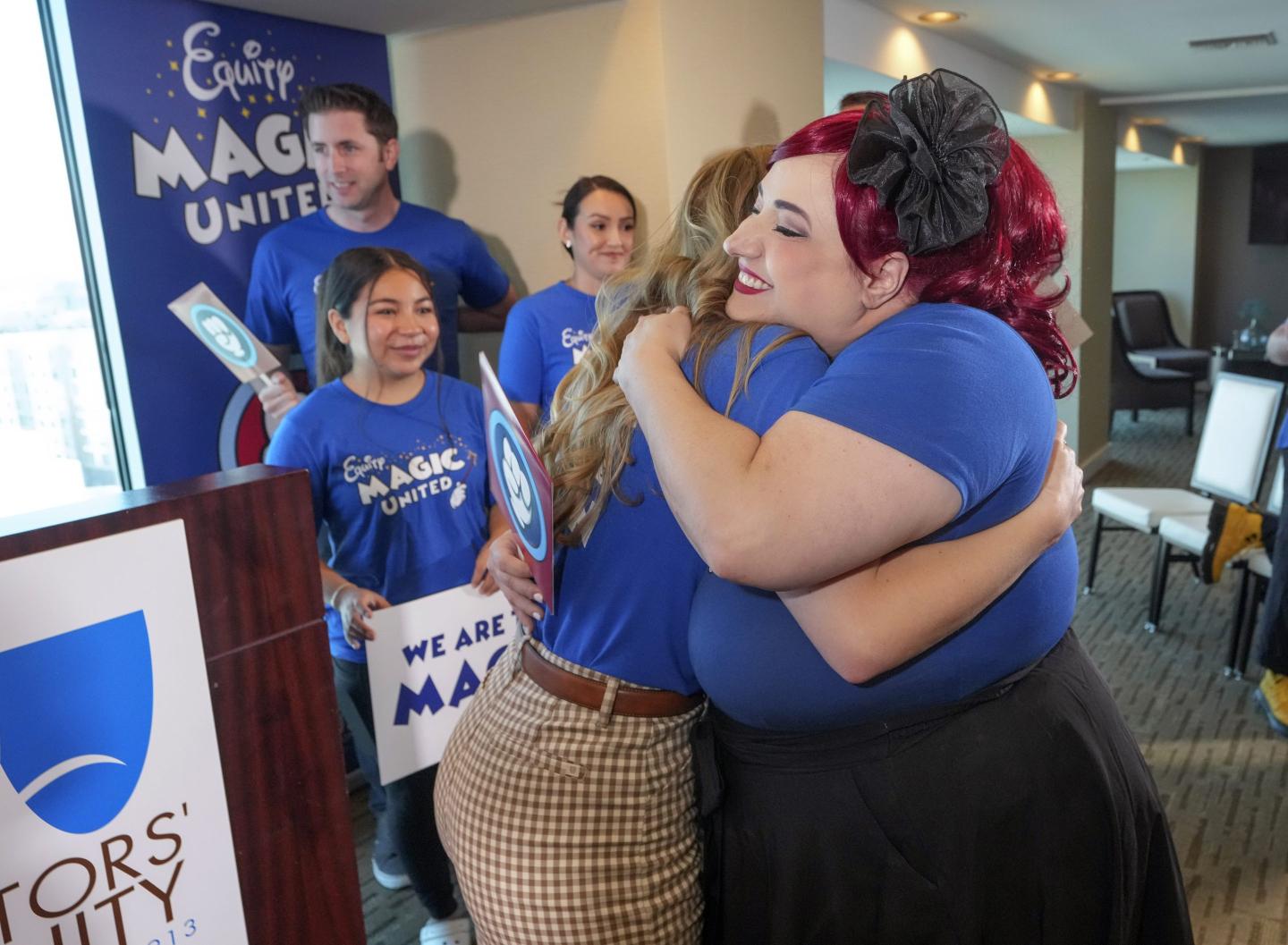 Disneyland performers hug each other