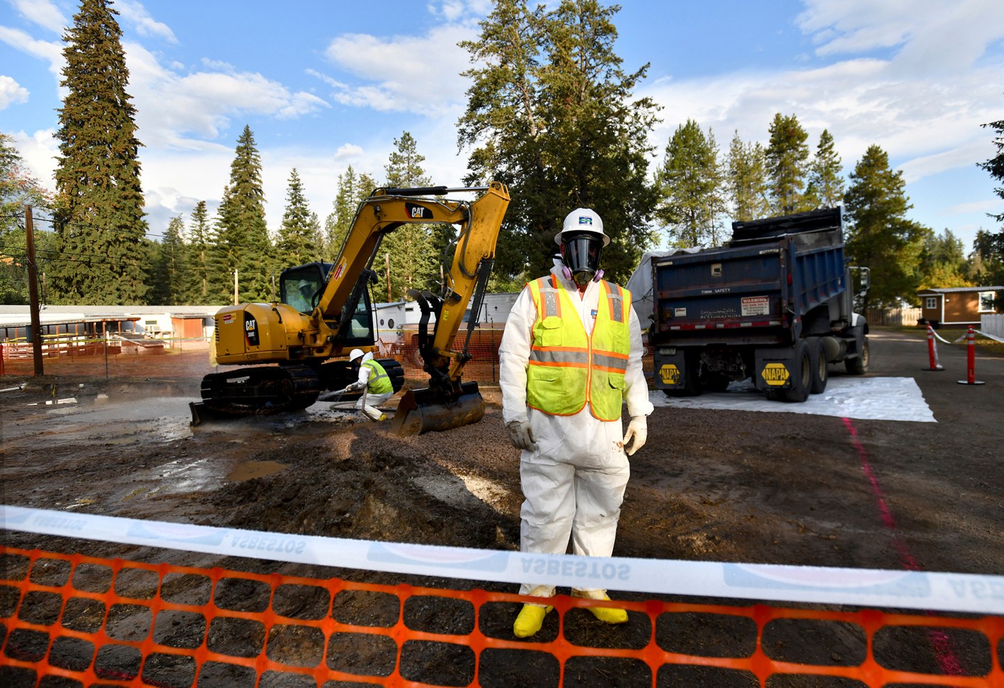 Environmental cleanup specialists work at one of the last remaining residential asbestos cleanup sites in Libby, Montana, in mid-September.