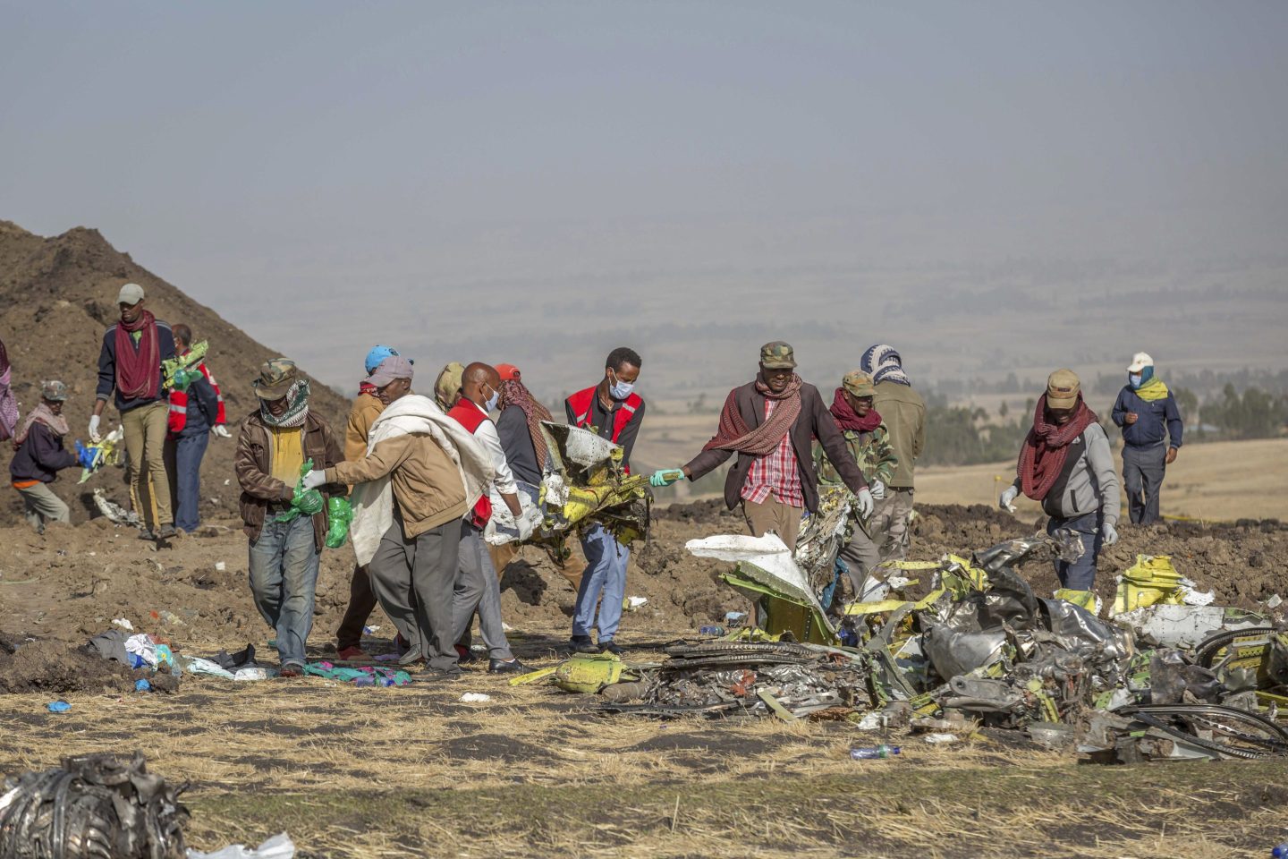 escuers work at the scene of an Ethiopian Airlines flight of a Boeing 737 Max 8 plane crash near Bishoftu, or Debre Zeit, south of Addis Ababa, Ethiopia, March 11, 2019.