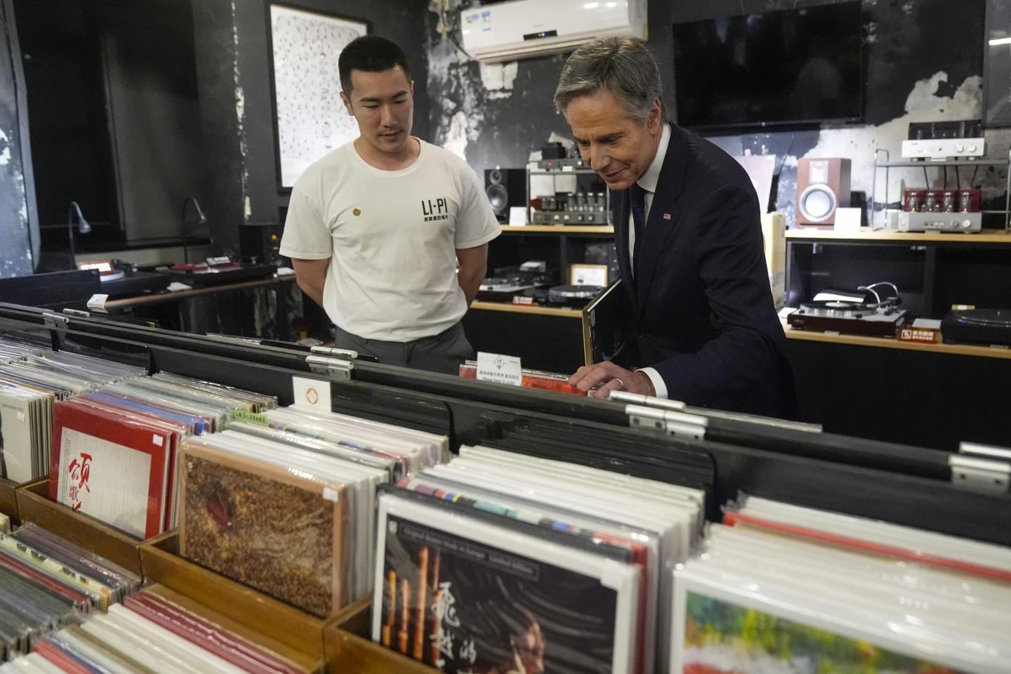 Antony Blinken looks through records at store