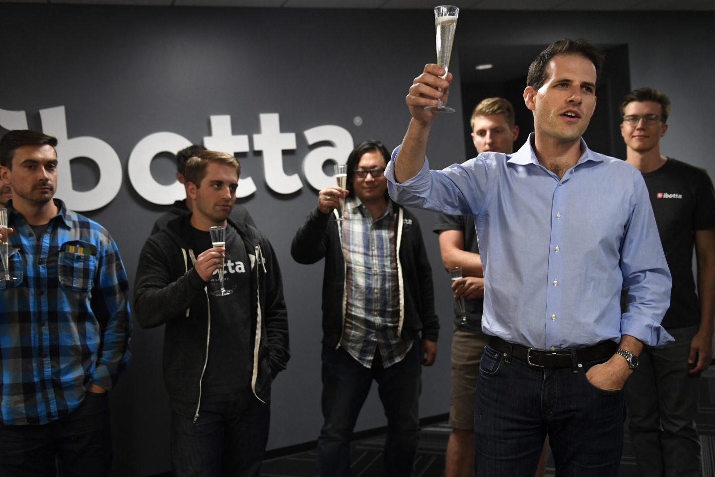 CEO Bryan Leach toasts with colleagues after after the relaunch of Ibotta's mobile app.