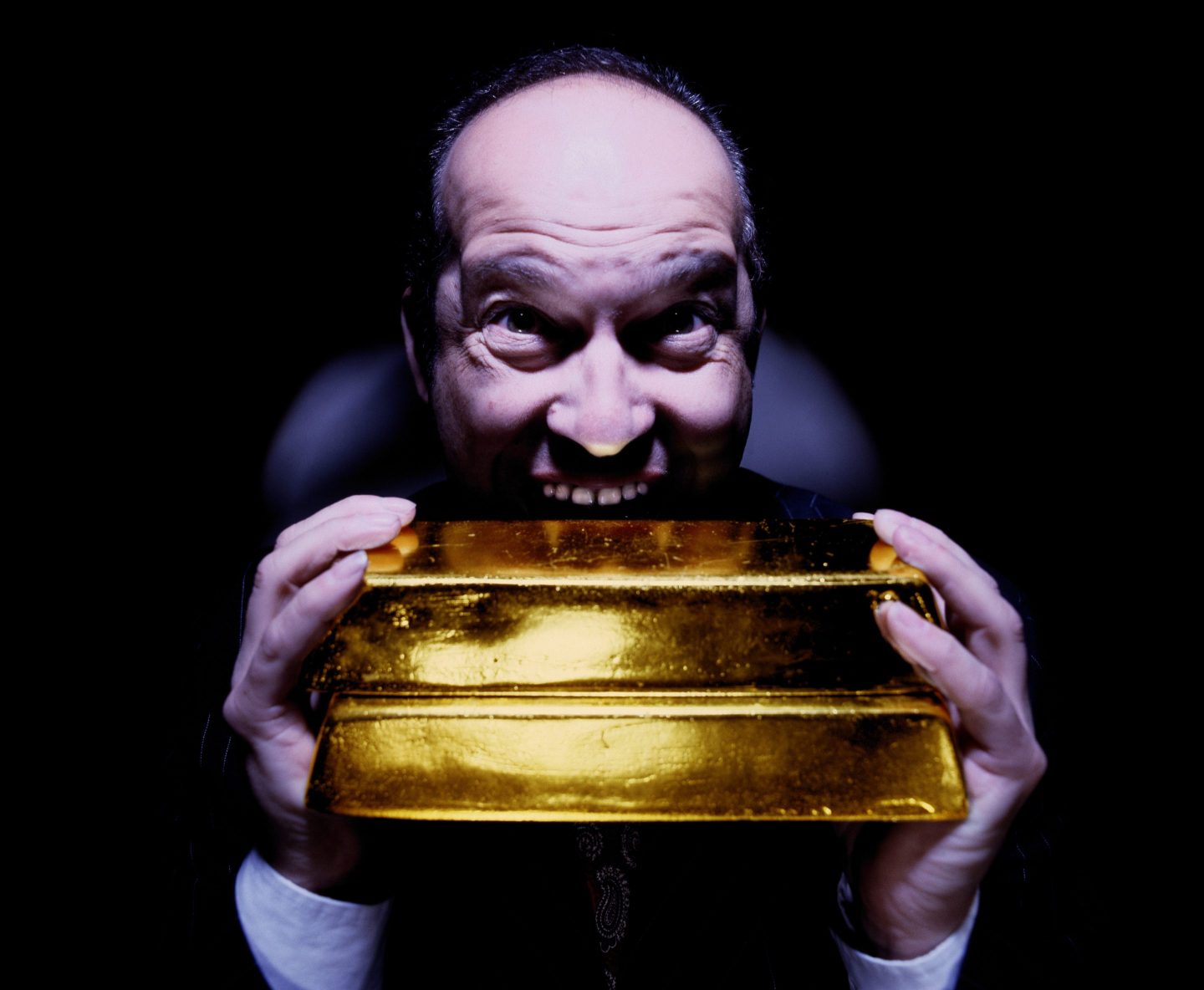 man holding gold bars