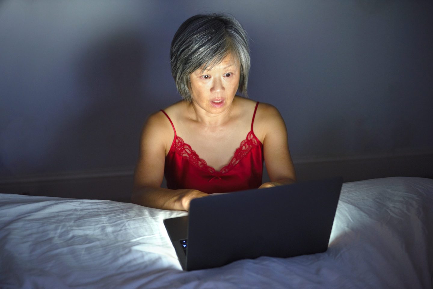 Photo of woman looking at her laptop screen with concern