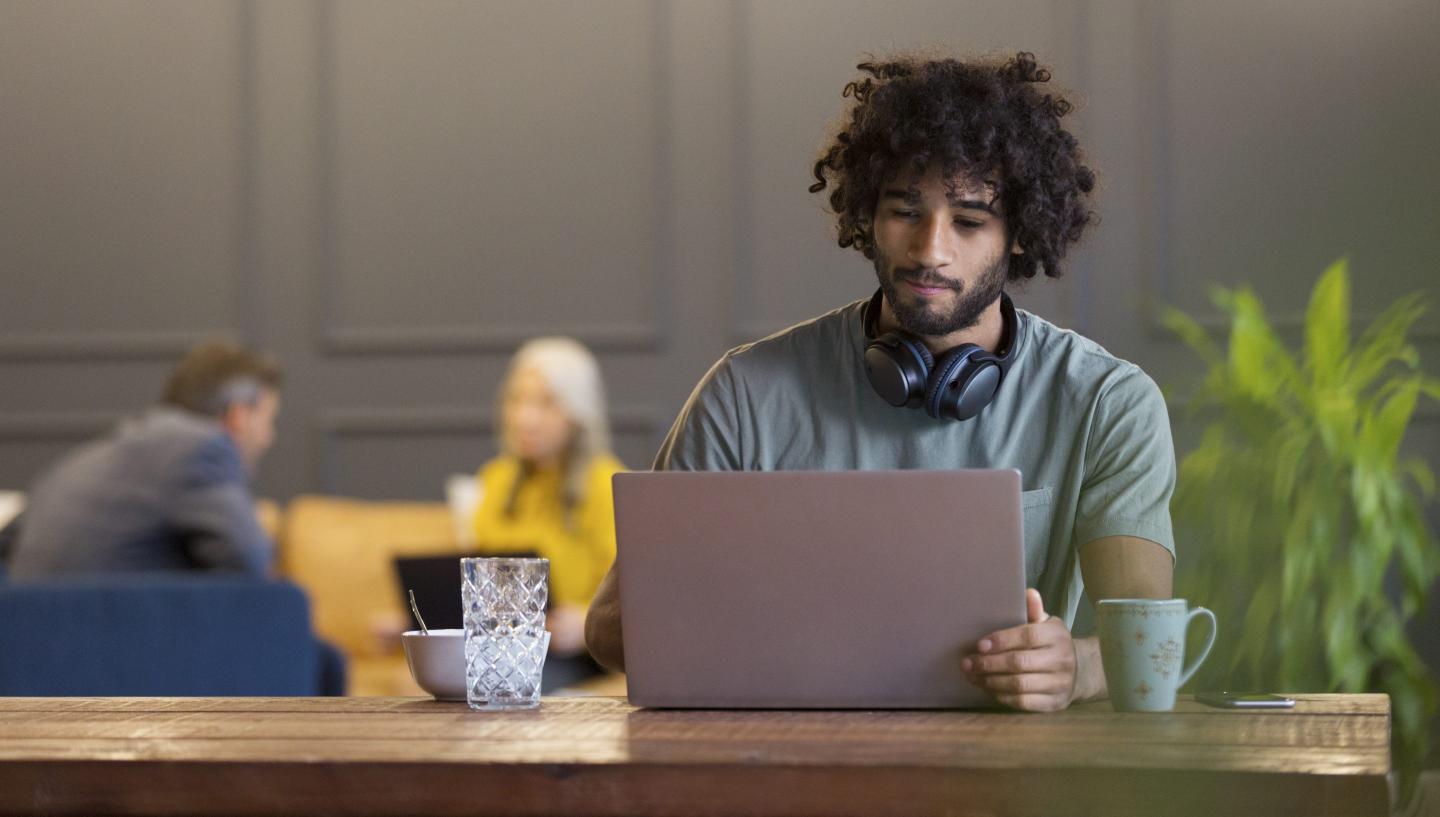 Young man using laptop in co-working space