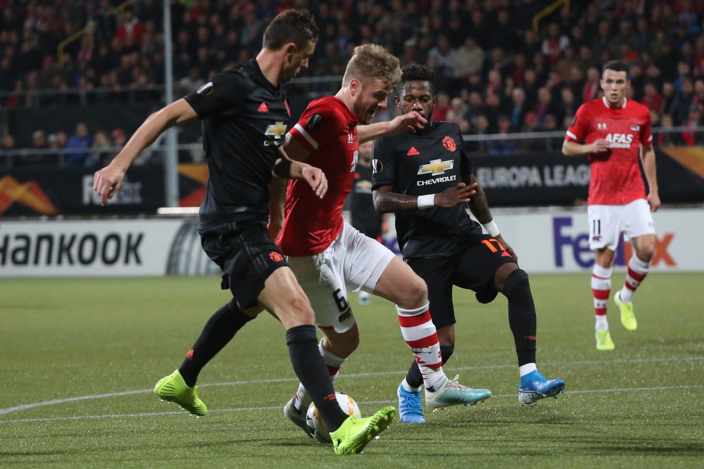 a group of men with a football in front of them