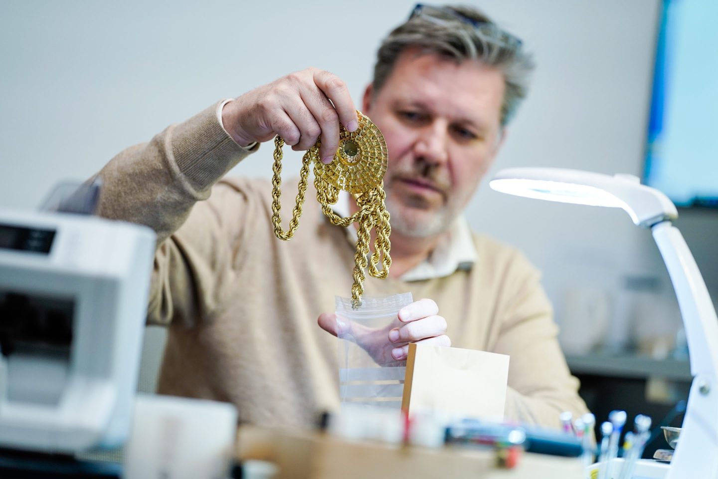 man holding gold chain