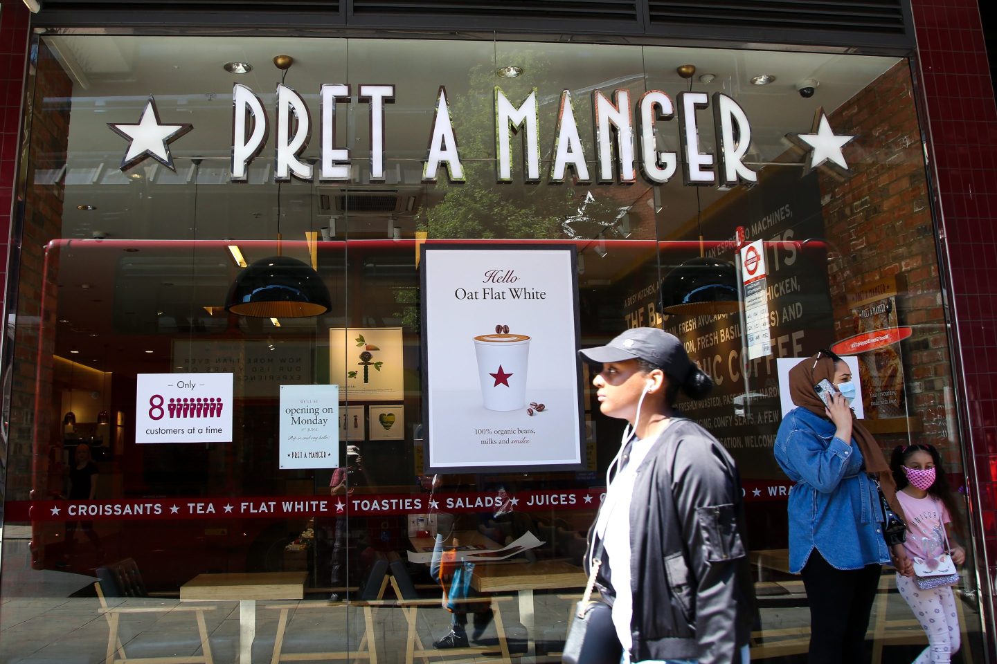 A woman walks past a branch of Pret A Manger in north London