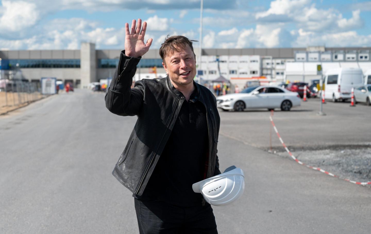Elon Musk waves