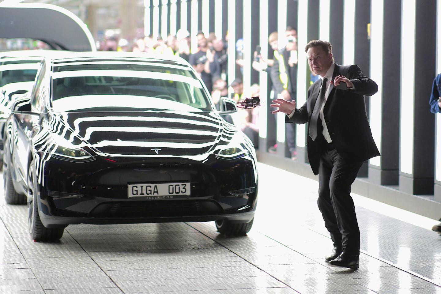 Elon Musk stands near Model Y
