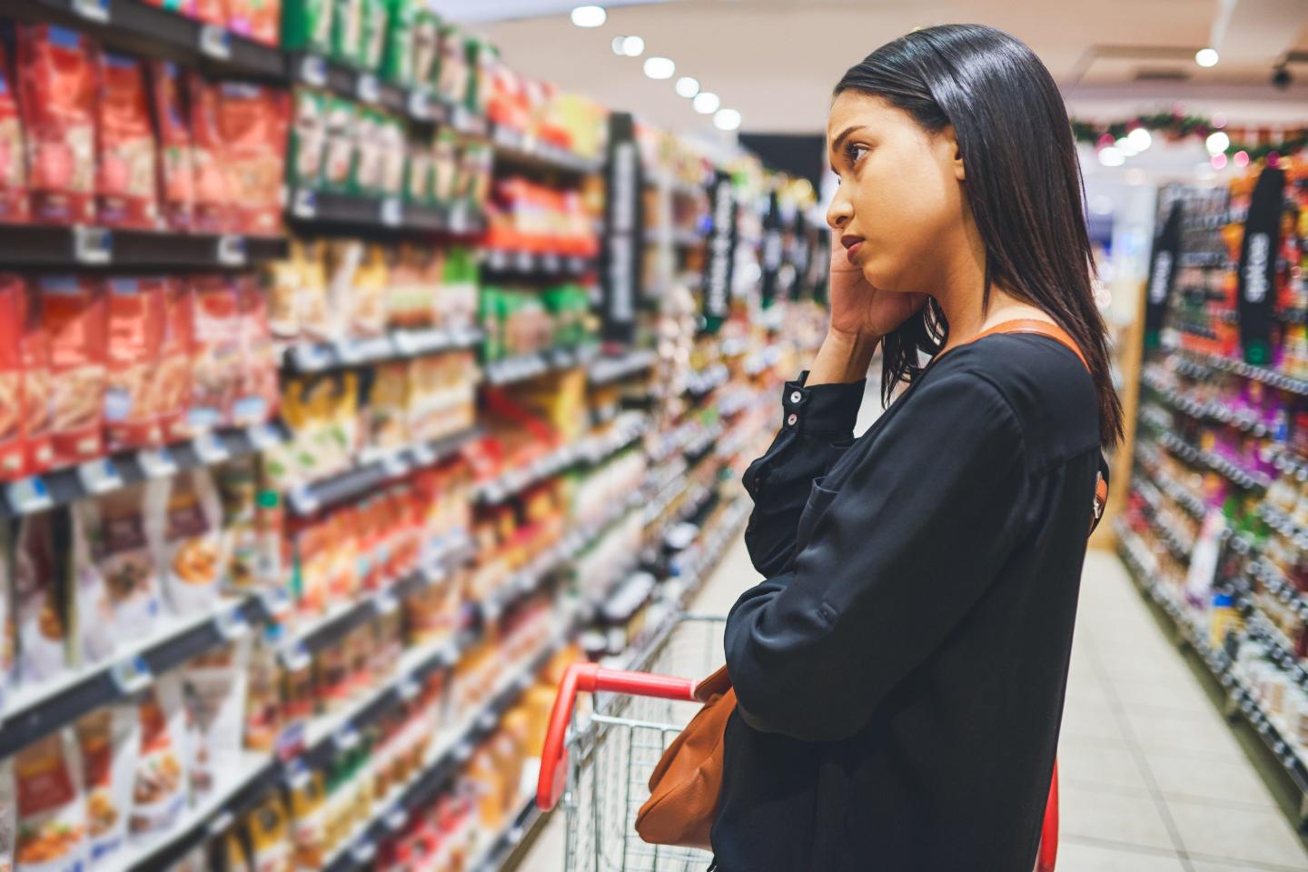 Woman in supermarket aisle