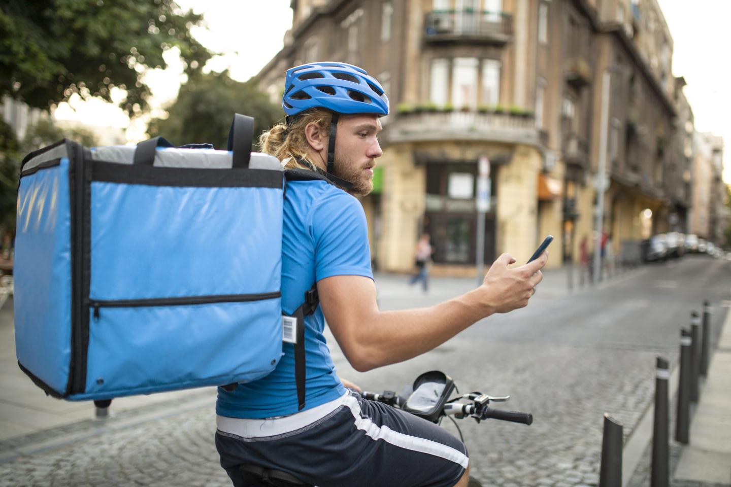 Photo of delivery person on a bicycle