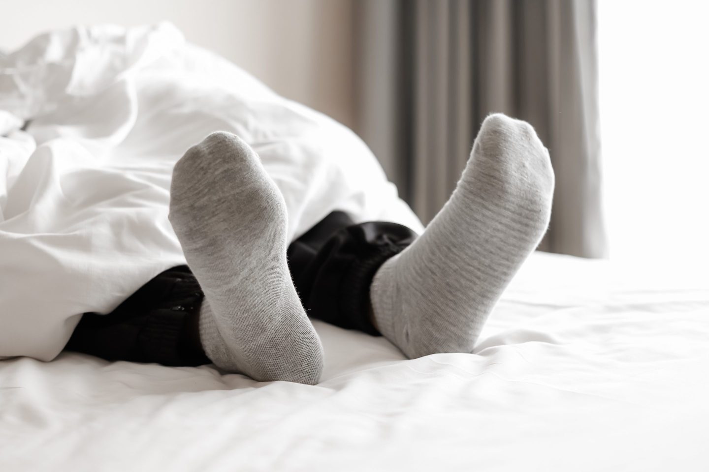 Sleeping in socks helps to regulate your body temperature, which can lead to falling asleep faster, waking up less, and sleeping in later.