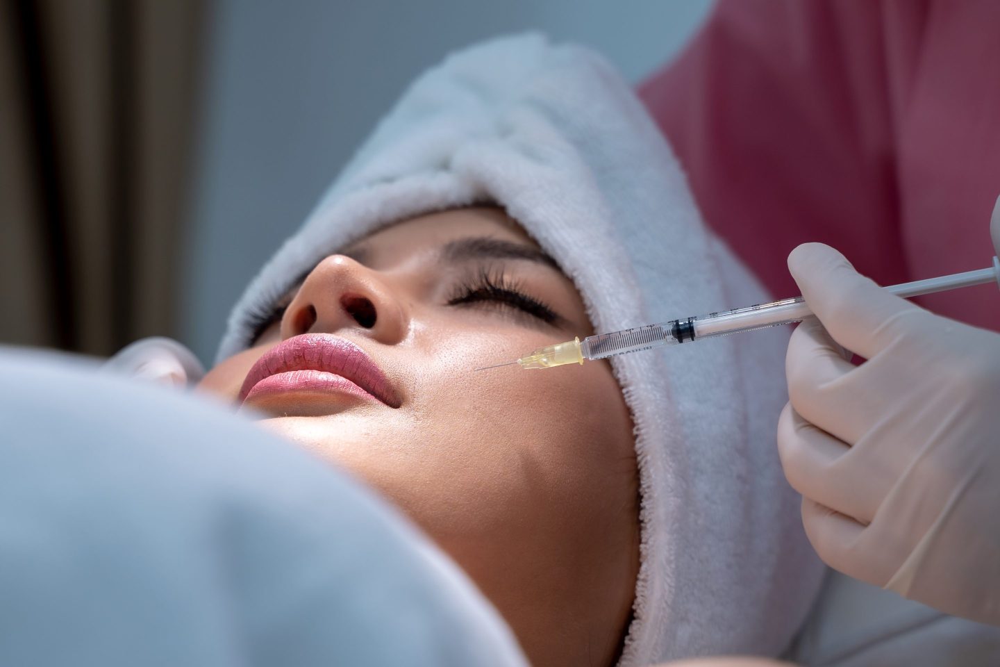 Young woman getting a facial injection