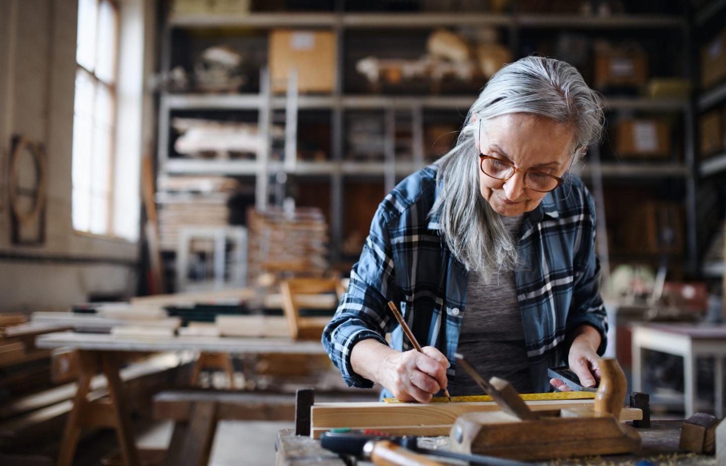 A woman works at a carpentry bench