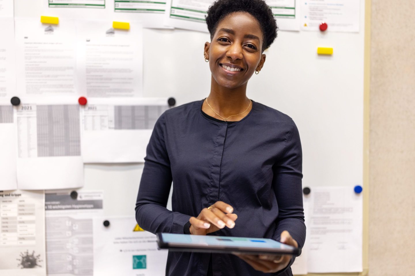 Portrait of a confident woman warehouse manager with a digital tablet