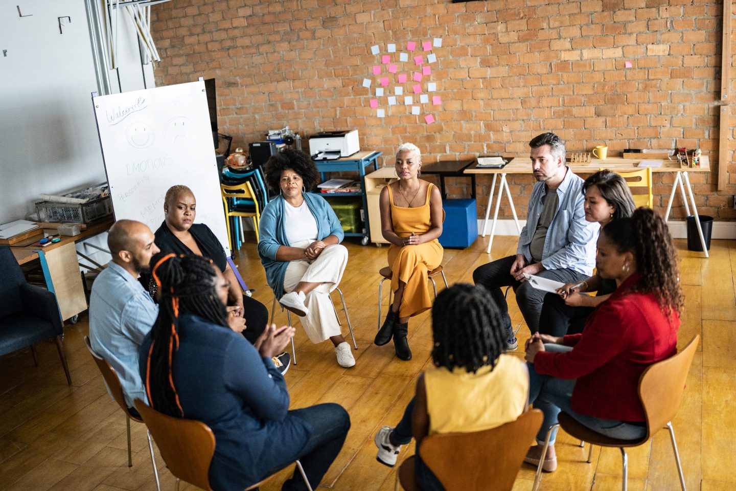 A group of people sitting in a circle chatting