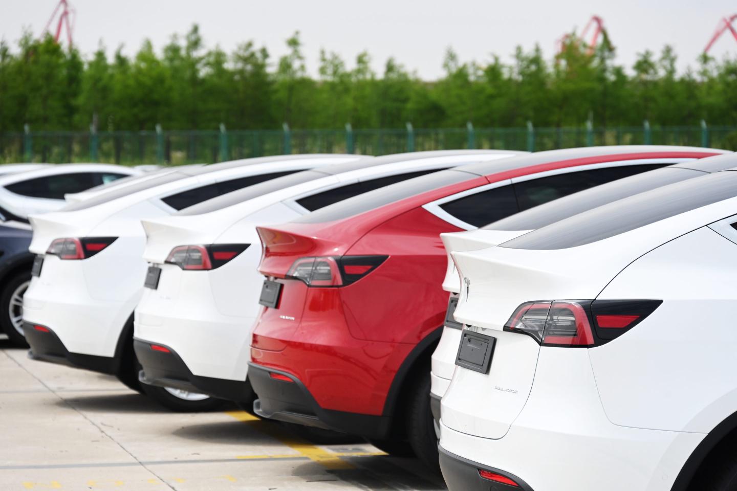 Tesla cars in a parking lot.