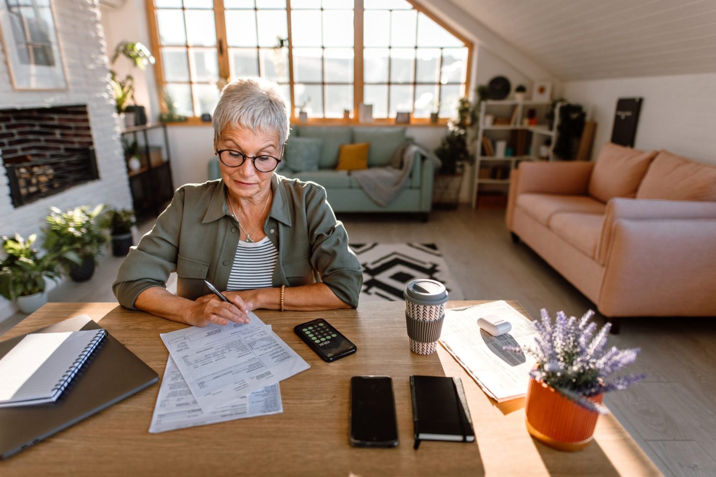 Senior woman doing home finances at home.